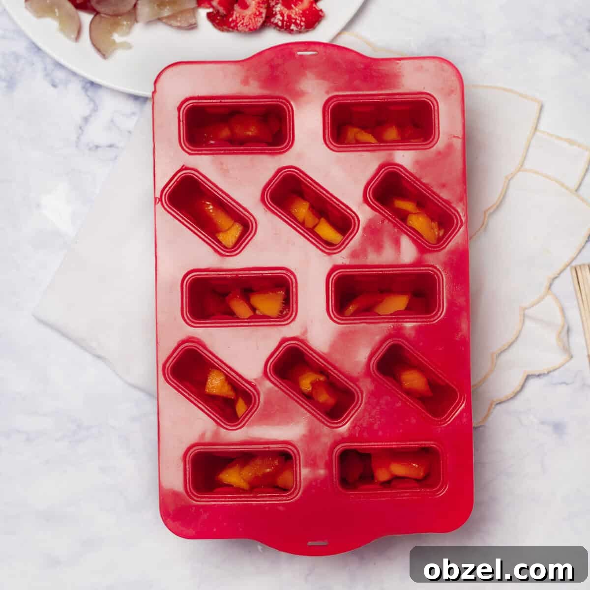 Low-Point Yogurt and Fruit Ice Pops | WW Points 4 Chopped strawberries added to the bottom of popsicle molds.