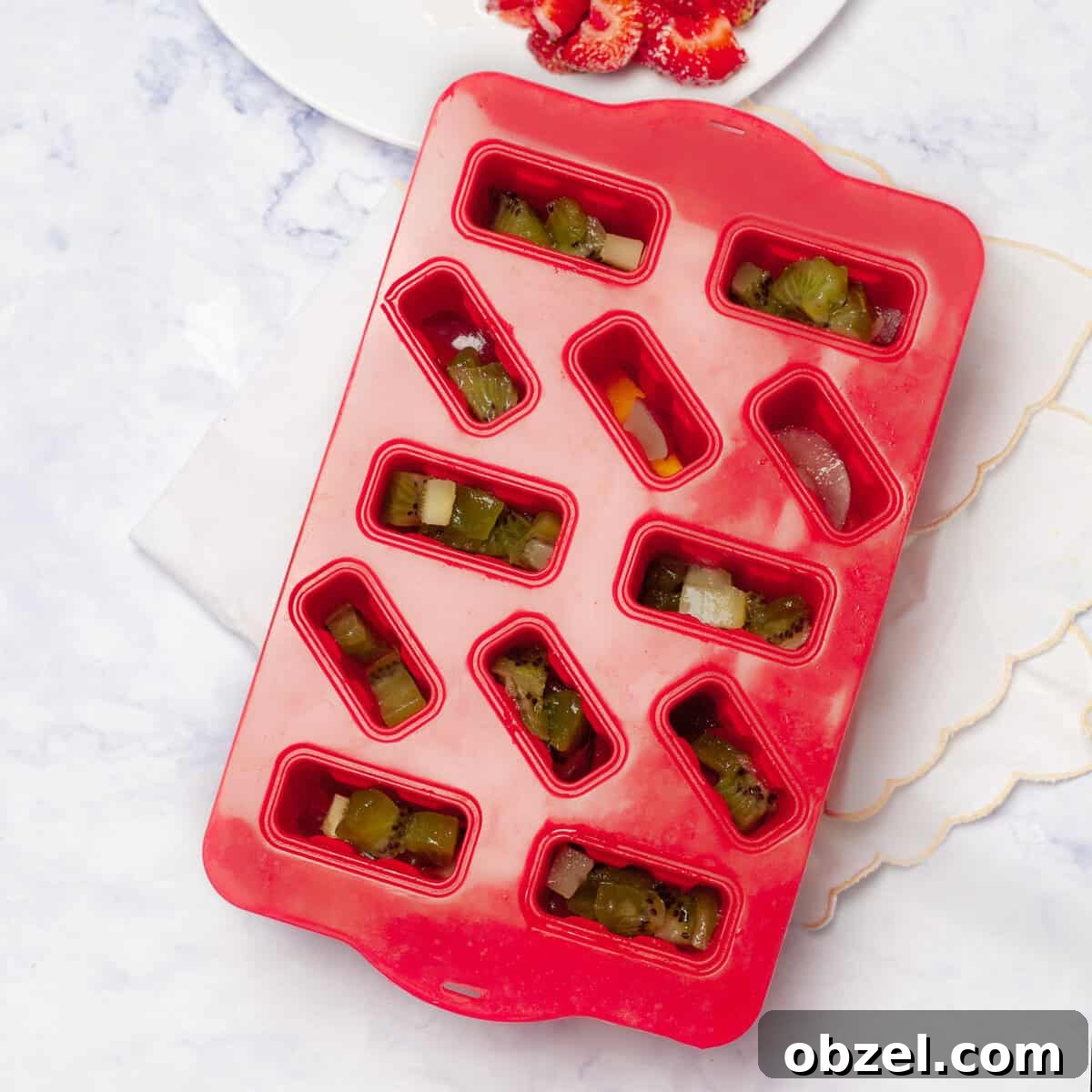 Low-Point Yogurt and Fruit Ice Pops | WW Points 5 Kiwis and mangos added to the chopped strawberry in popsicle molds.
