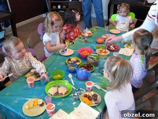 Tinker Bell Tea Party: Decorations, Games and Treats 7 little girls sitting around table for birthday party