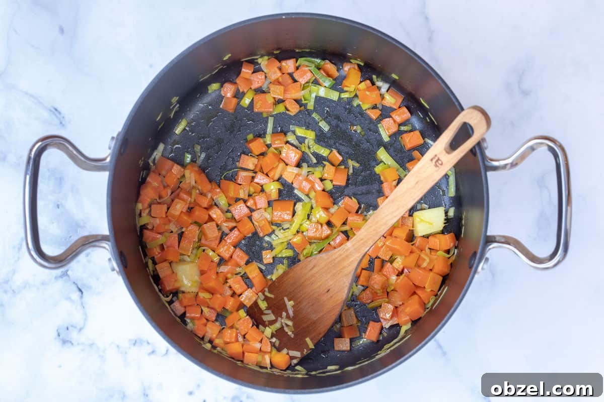 chopped carrots, sliced leeks, and ginger in large stockpot
