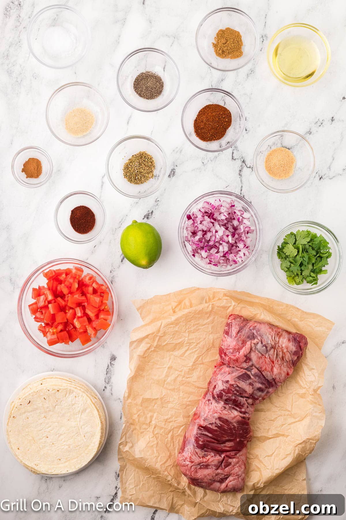 Juicy Blackstone Steak Tacos with Charred Onions and Lime 3 Ingredients - Steak, avocado oil, chili powder, cumin, garlic powder, salt, pepper, oregano, onion powder, smoked paprika, cinnamon, corn tortillas, diced tomatoes, red onion, fresh cilantro, lime wedges