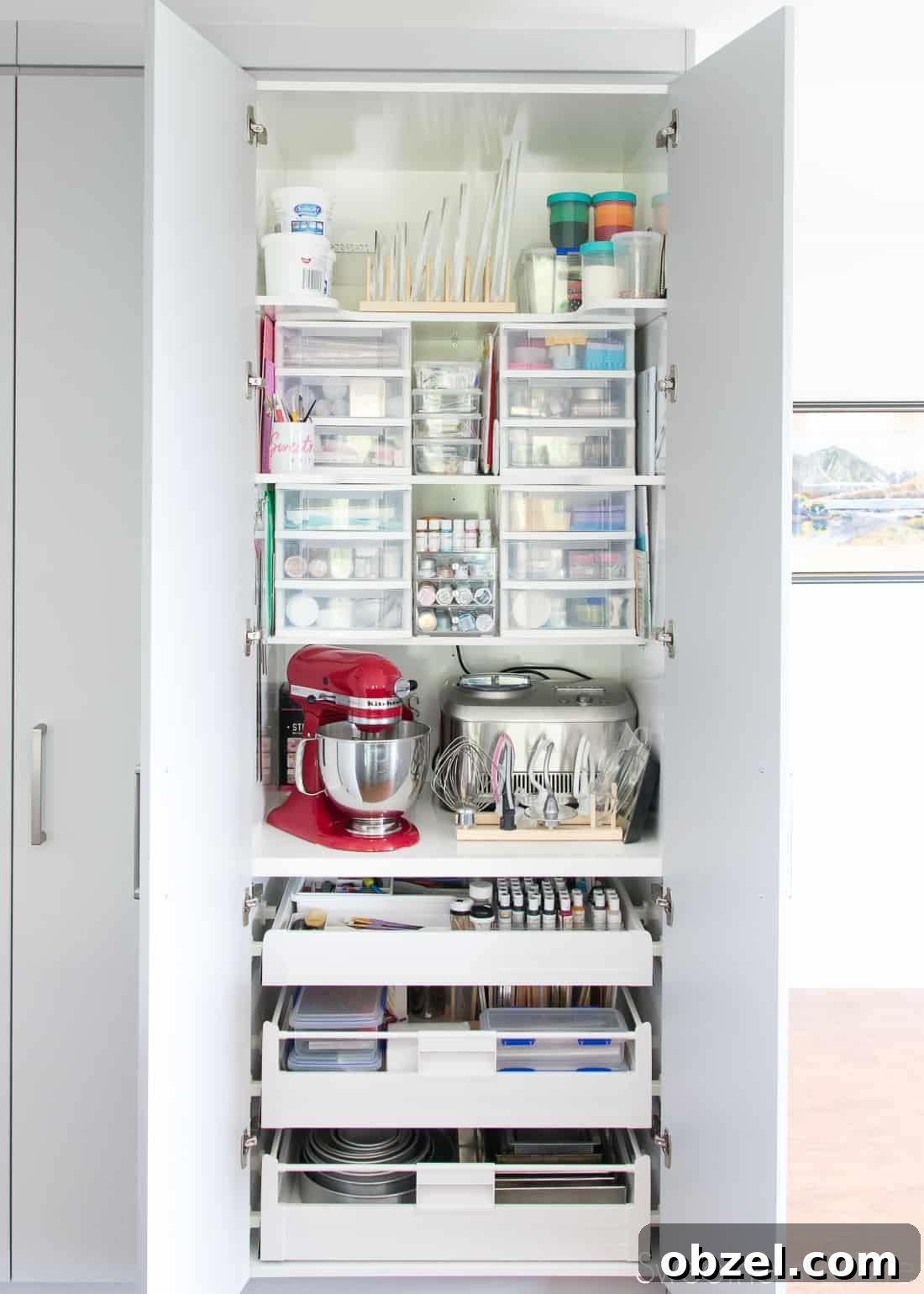 Kitchen Renovation and New Cake Pantry Reveal 20 A large, floor-to-ceiling pantry filled with cake decorating supplies and tools.