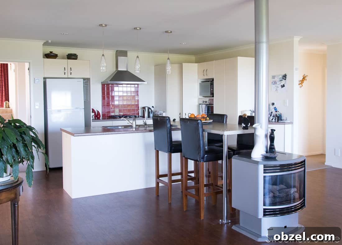 Kitchen Renovation and New Cake Pantry Reveal 3 An ugly old kitchen with a red tile splashback, a very small bench, a long, too high breakfast bar, and a gas fireplace at the end.