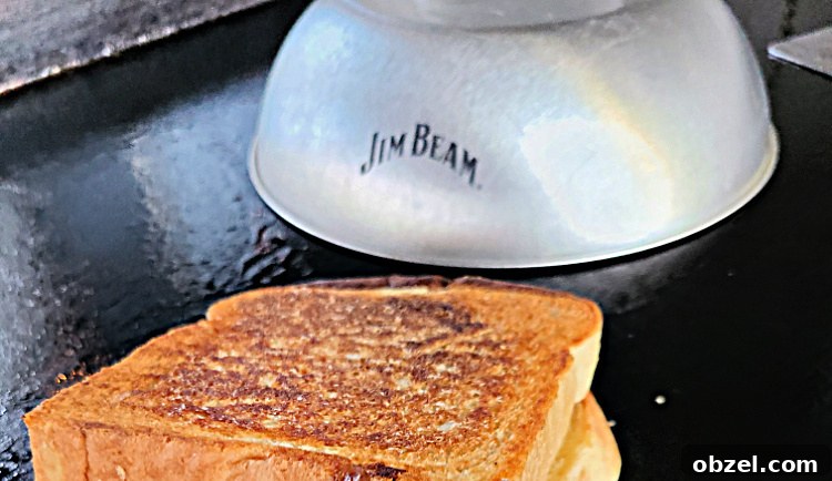 Sloppy Joe Grilled Cheese on a Blackstone Griddle 5 Sloppy Joe Grilled Cheese On A Blackstone Griddle next to a Jim Beam melting dome