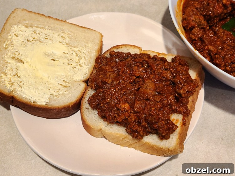 Sloppy Joe Grilled Cheese on a Blackstone Griddle 3 Sloppy Joe Grilled Cheese bread next to bowl full of sloppy joe