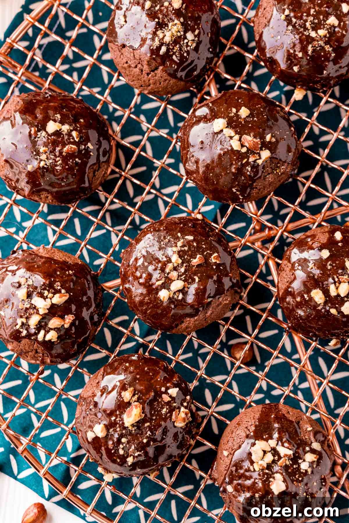 Texas Sheet Cake Cookies with Fudgy Chocolate Frosting 6 Overhead photo of texas sheet cake cookies on a copper wire rack on a blue napkin.