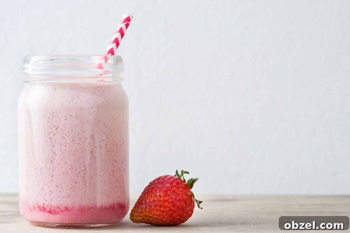 Homemade Strawberry Puree for Babies 9 strawberry milk with a strawberry next to it