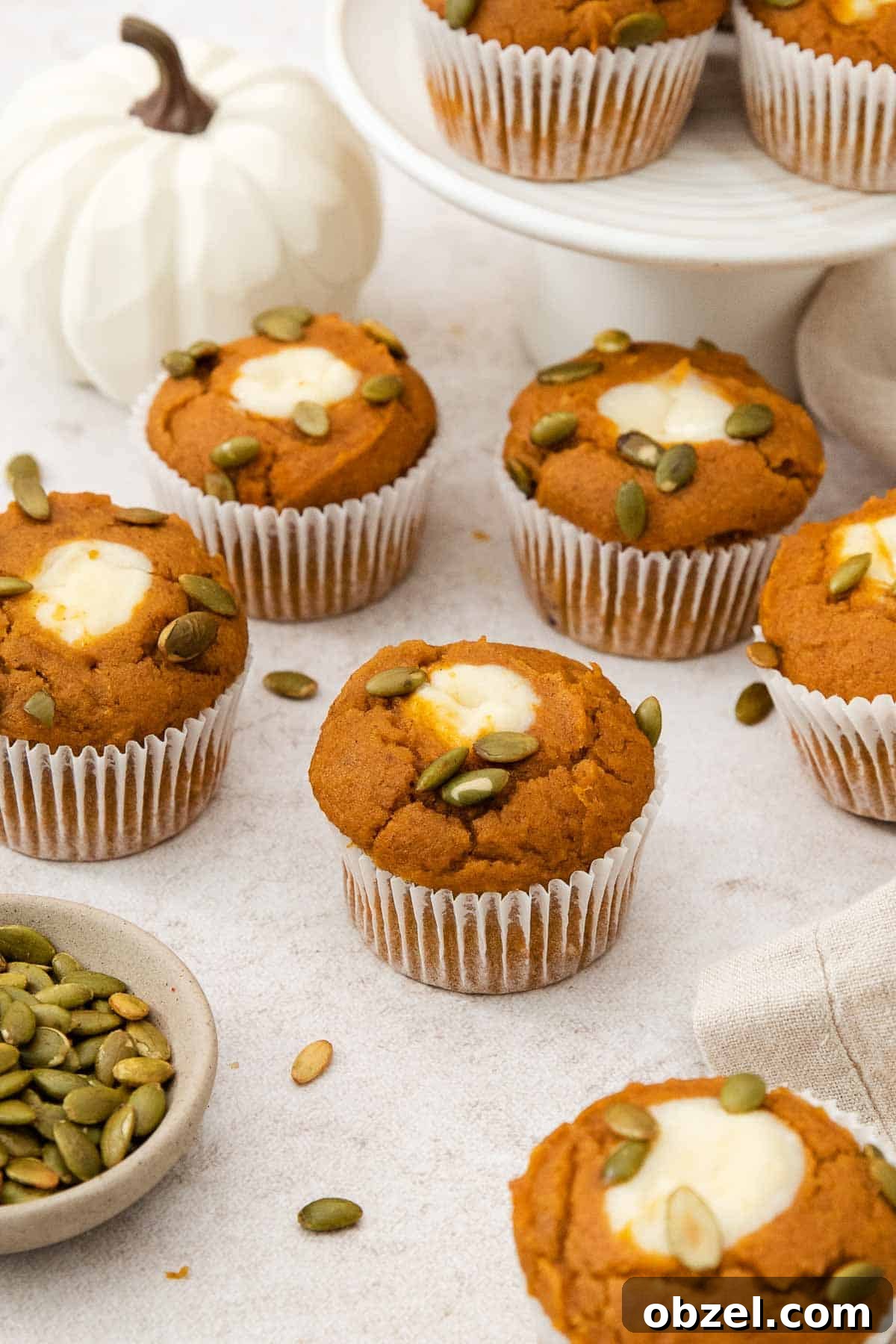 Gluten-free pumpkin cream cheese muffins on a countertop.