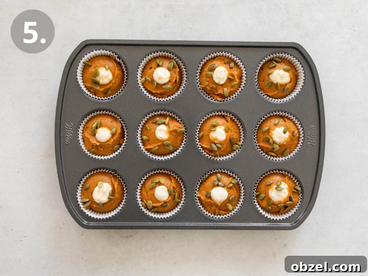 Gluten-free pumpkin cream cheese muffins in a muffin tin.
