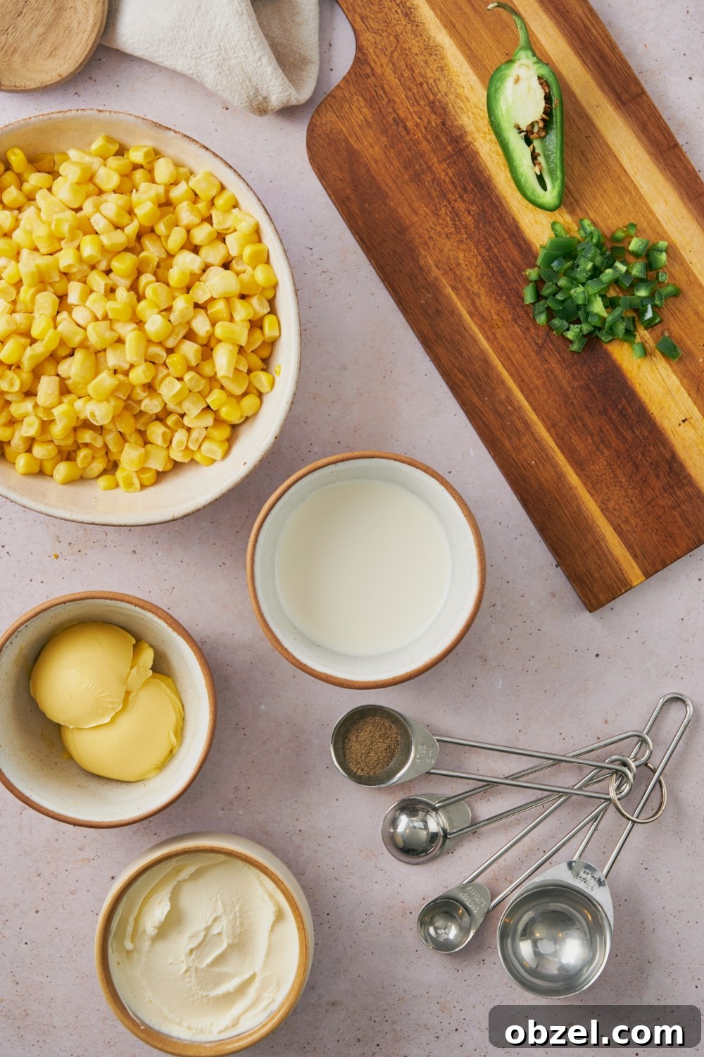 Jalapeno Corn Casserole with Cheddar 4 corn, butter, cream cheese, chopped jalapeno, and pepper in separate bowls.
