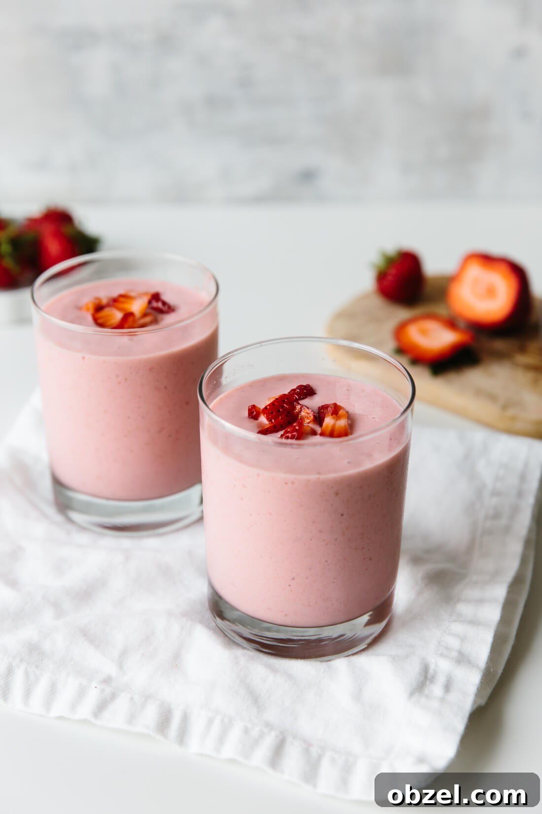 Two glasses of strawberry banana smoothie.