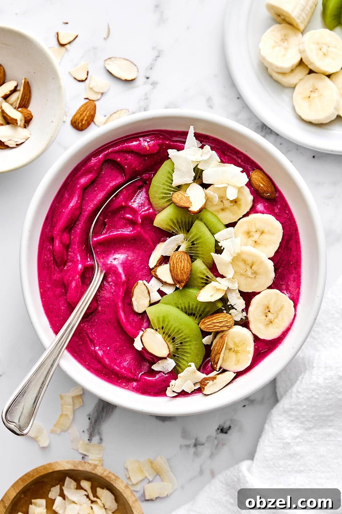 Pitaya smoothie bowl with fruits on top.