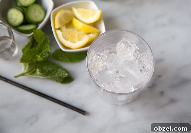 Summer Pimms Cup Cocktail Recipe 4 serving glass filled with ice cubes