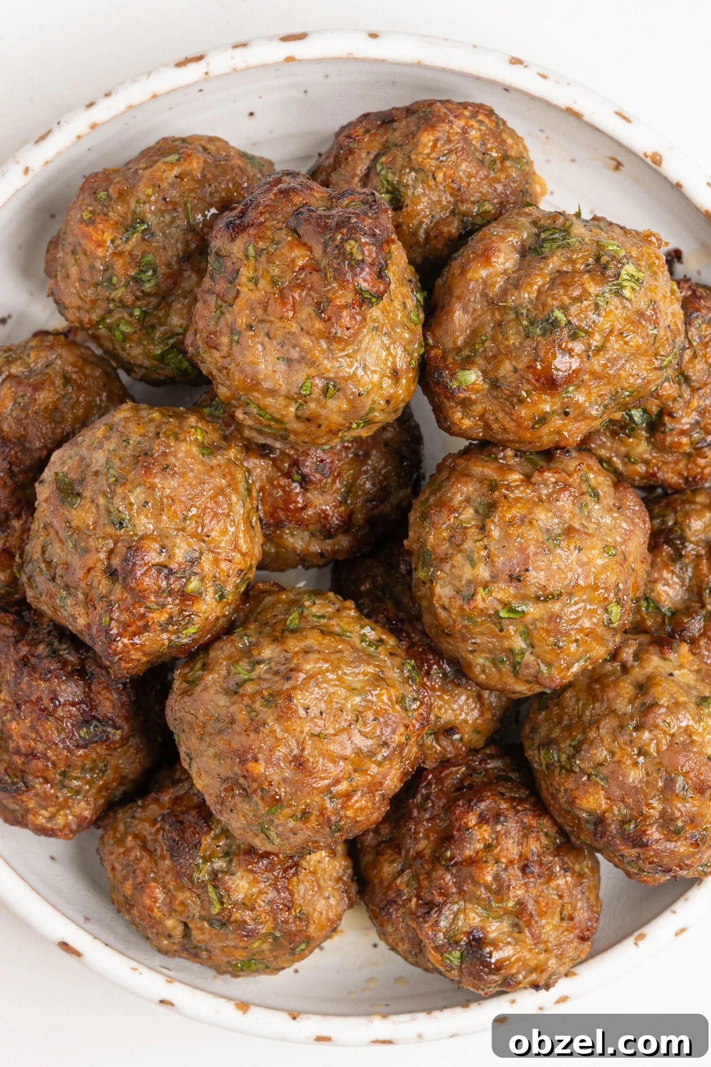 Tender Juicy Baked Moroccan Lamb Meatballs 2 A bowl of baked lamb meatballs.