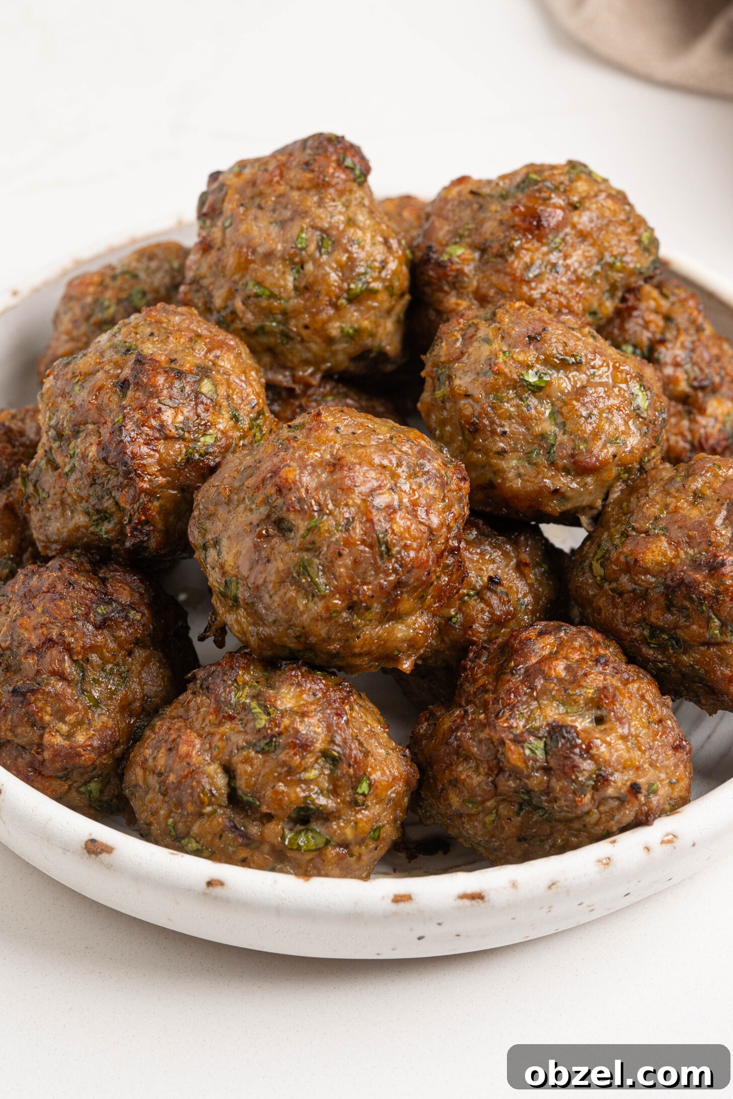 Tender Juicy Baked Moroccan Lamb Meatballs 18 A bowl of baked lamb meatballs.