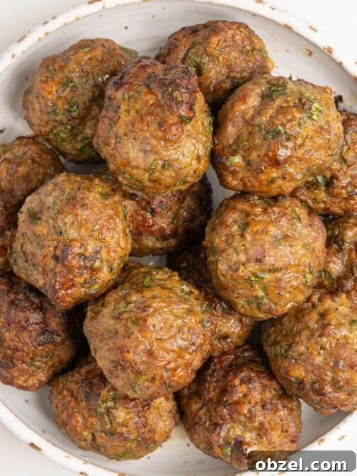 A bowl of baked lamb meatballs.