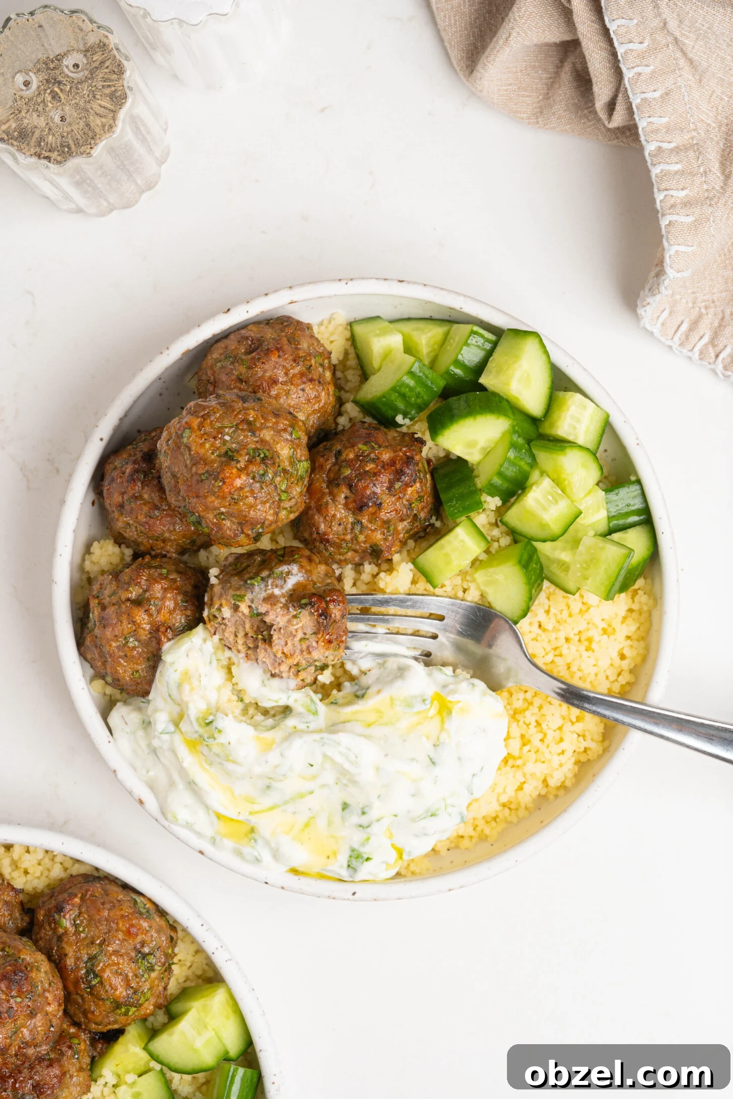 Tender Juicy Baked Moroccan Lamb Meatballs 9 A bowl of couscous, lamb meatballs, and more.