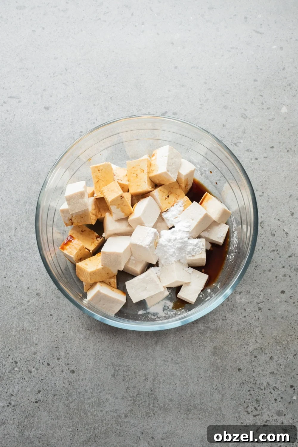 Crispy Thai Peanut Tofu Bowl 8 An overhead image of mixing the tofu with cornstarch and soy sauce.