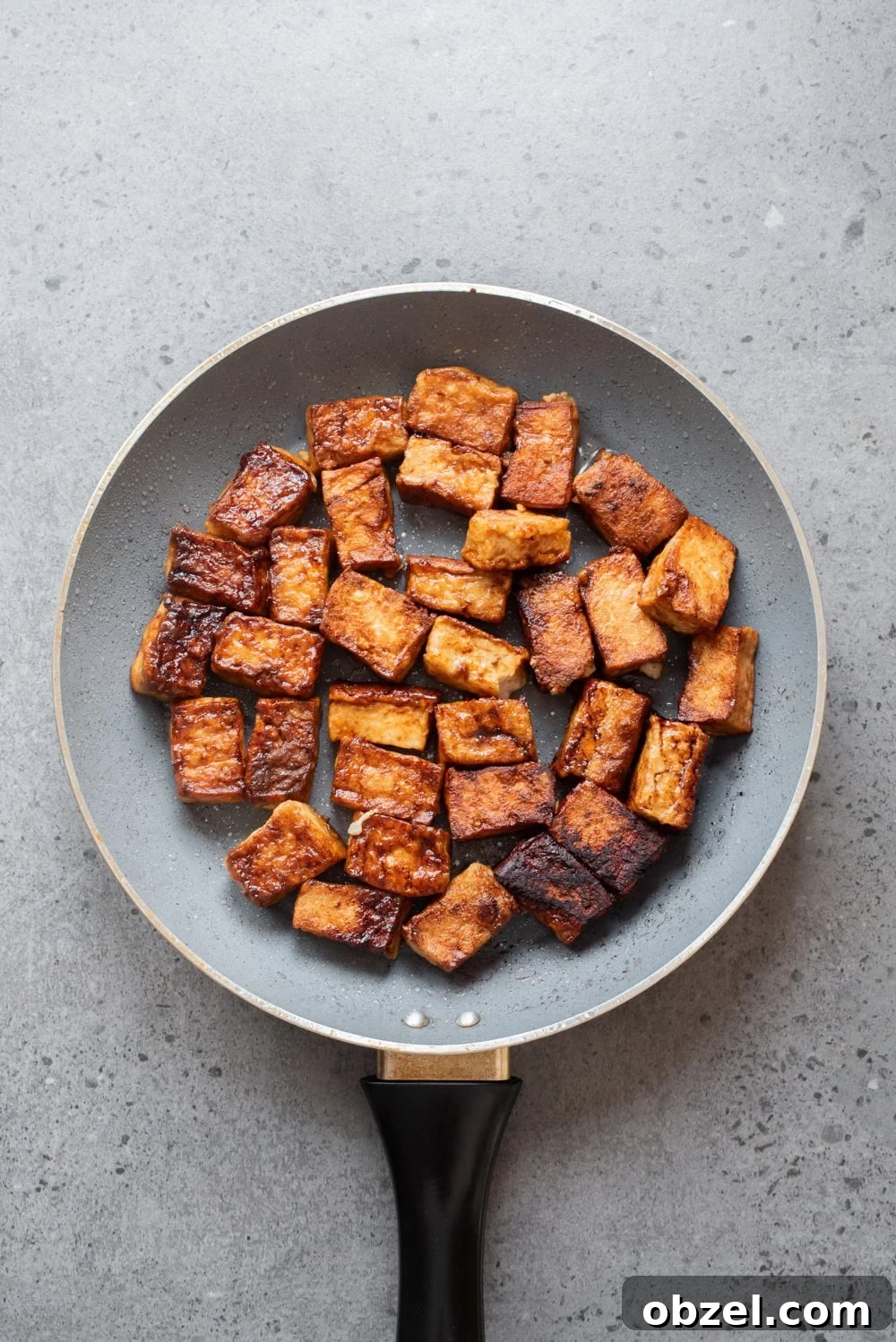 Crispy Thai Peanut Tofu Bowl 10 An overhead image of crispy tofu in a pan.