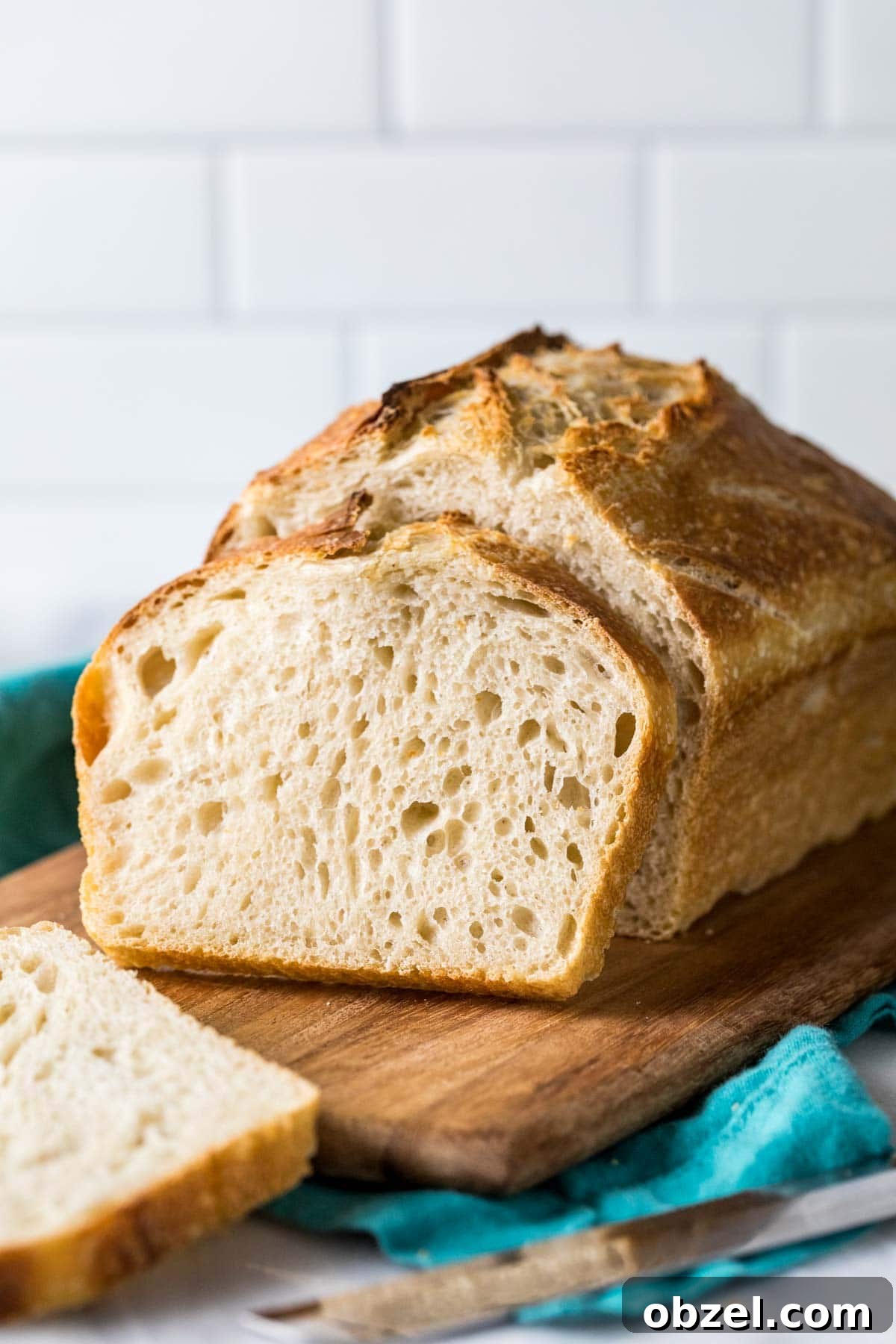Homemade Sourdough Bread Recipe with Starter 2 Photo of the bread from my sourdough bread recipe showing a loaf with a slice resting against it.