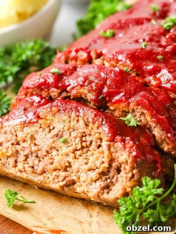 Homemade Sourdough Bread Recipe with Starter 14 Meatloaf with one slice cut to show the interior.