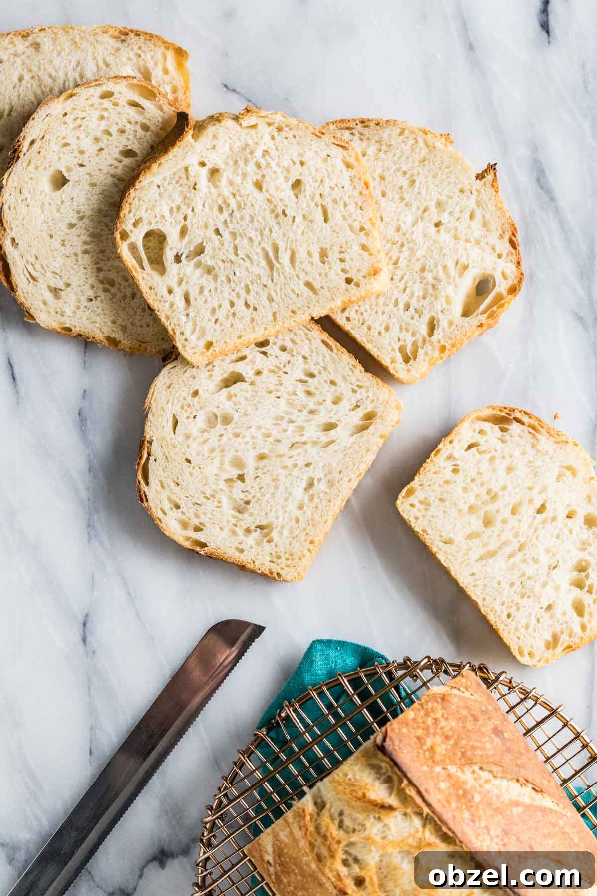 Homemade Sourdough Bread Recipe with Starter 4 Slices of homemade bread after being cut off a loaf.