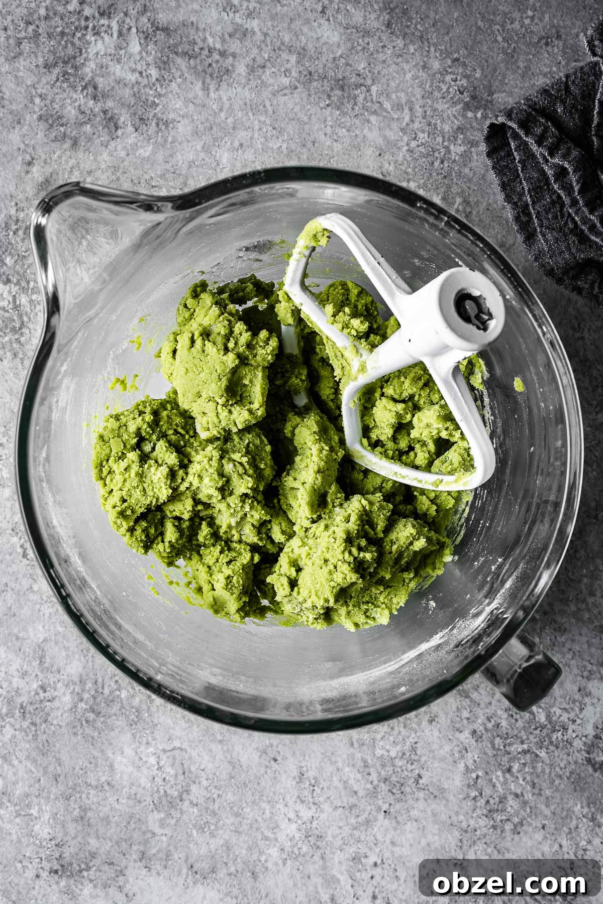 Matcha White Chocolate Cookies Recipe 7 Green matcha cookie dough in a mixing bowl.