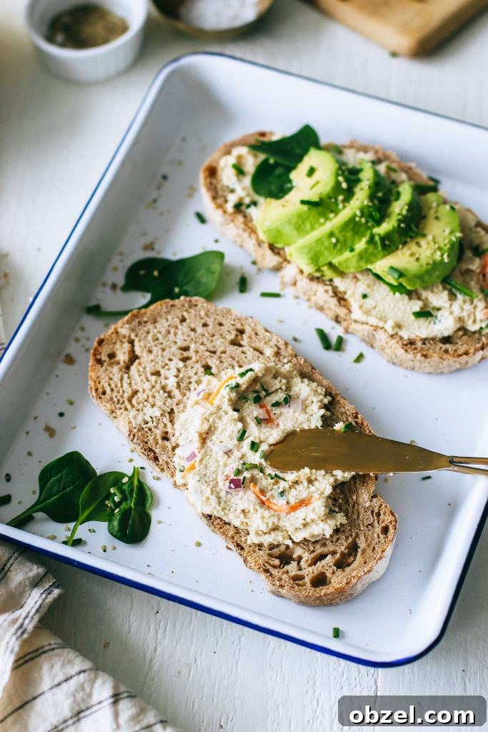 veggie cream cheese on toast with avocado spinach on white tray