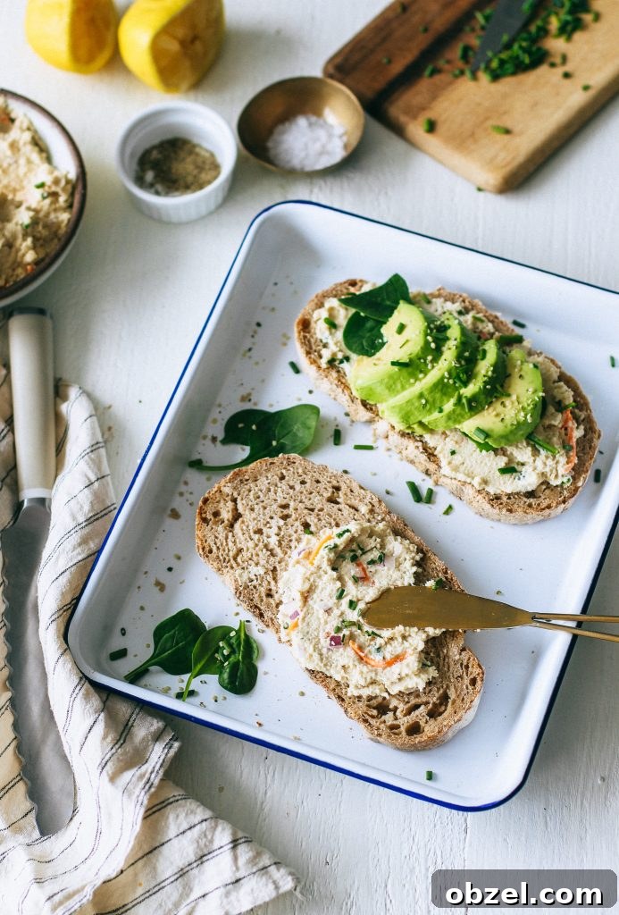 veggie cream cheese on toast with avocado spinach on white tray