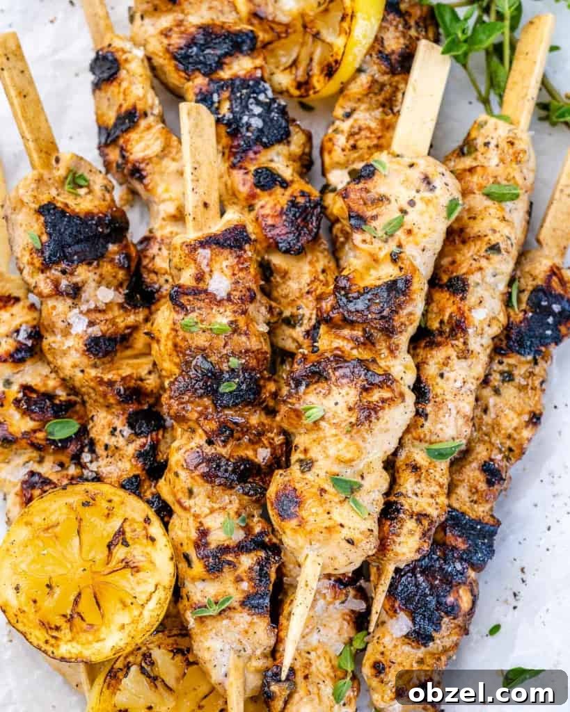 Grilled Lemon Chicken Skewers with Garlic and Herbs 2 grilled lemon and pepper chicken skewers on kabobs