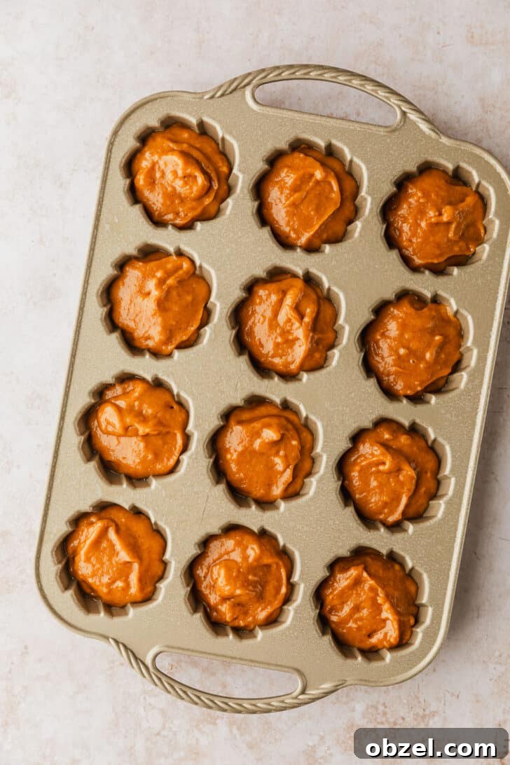 Pumpkin Spice Mini Bundt Cakes 9 A pan of unbaked pumpkin mini bundt cakes.