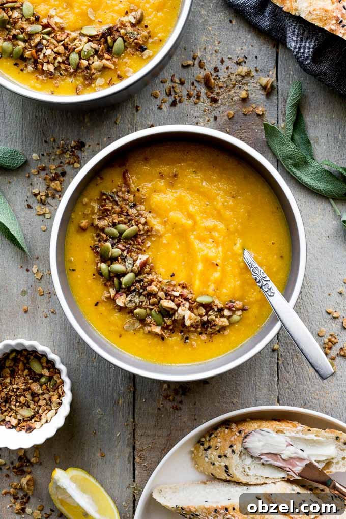 Vegan Golden Beet Soup with Carrot and Ginger 2 Overhead view of bowls of golden beet soup on a wooden surface.