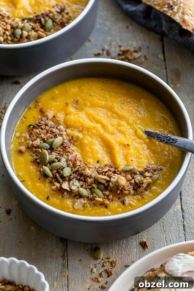 Vegan Golden Beet Soup with Carrot and Ginger 7 Up-close view of golden beet soup in a grey bowl.