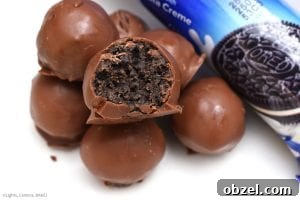 No Bake Caramel Oreo Truffles Recipe 4 Chocolate covered Caramel Oreo Truffles with cookies and cream filling.