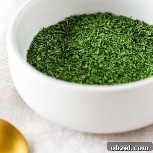 How to Dry Parsley in the Oven for Crisp, Flavorful Herbs 9 A small white ceramic bowl with oven dried parsley.
