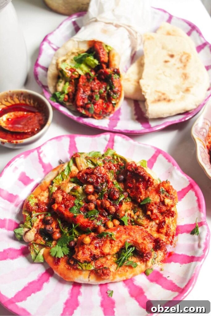 Honey and Harissa Glazed Halloumi Recipe 11 Two flatbreads with honey harissa halloumi, hummus and chickpeas on top.