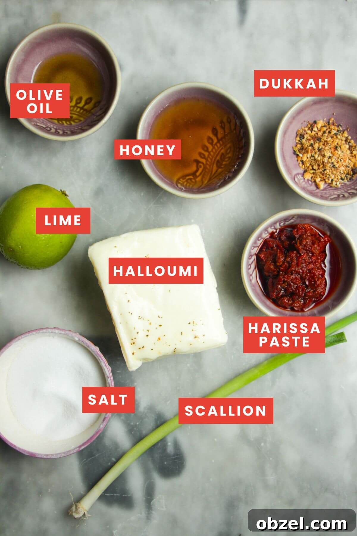 Honey and Harissa Glazed Halloumi Recipe 3 Ingredients for honey harissa halloumi laid out on a grey marble background.