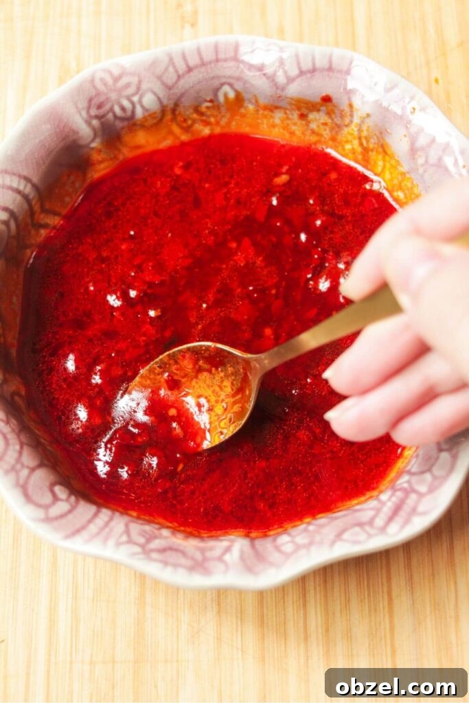 Honey and Harissa Glazed Halloumi Recipe 6 Mixing honey harissa sauce in a small pink bowl.
