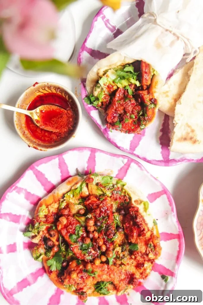 Honey and Harissa Glazed Halloumi Recipe 10 Two flatbreads with honey harissa halloumi, hummus and chickpeas on top.