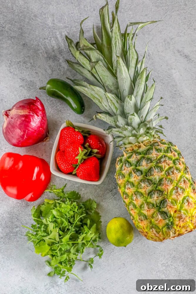 Fresh Pineapple Strawberry Salsa Recipe 5 Fresh pineapple, jalapeno, strawberries, onion, cilantro, lime, and bell pepper on a table