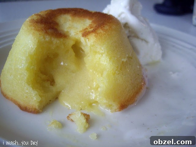 A close up of a White Chocolate Lemon Lava Cake broken open to expose the oozing center.