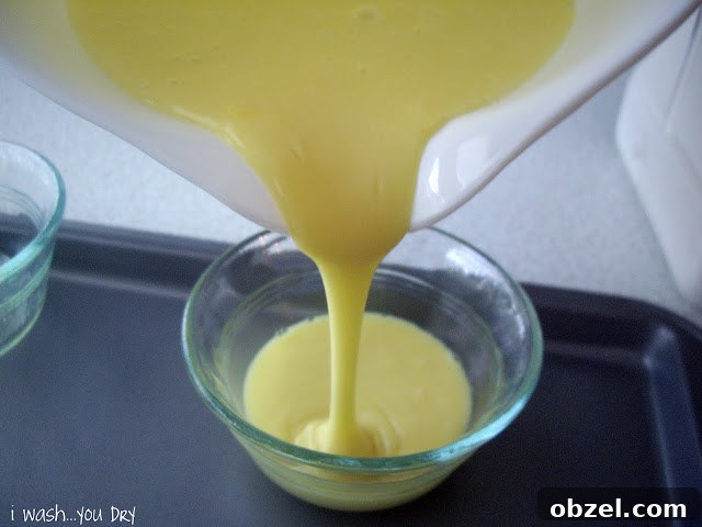 Batter being poured into a small glass dessert bowl.