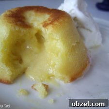 A close up of a White Chocolate Lemon Lava Cake broken open to expose the oozing center.