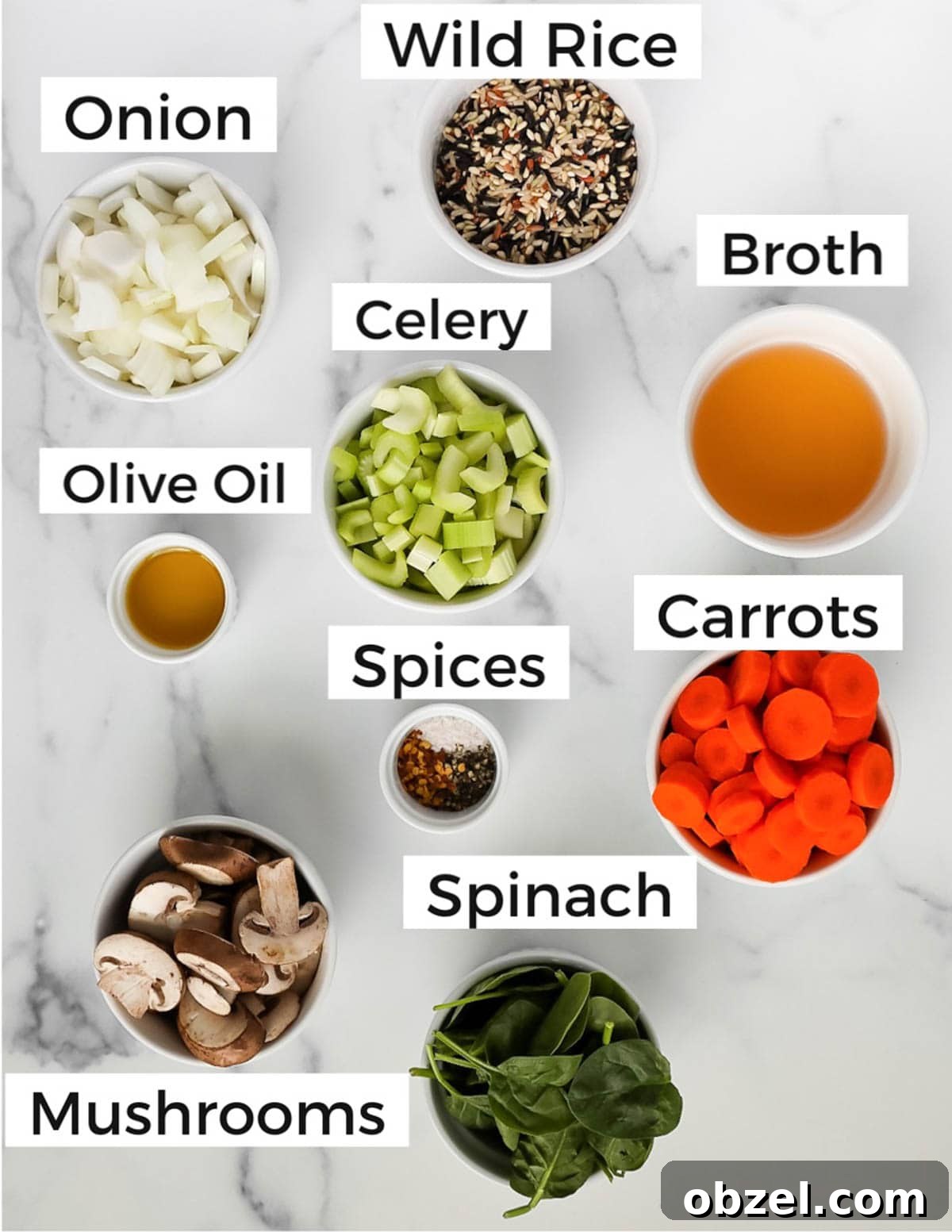 Creamy Wild Rice and Mushroom Soup Recipe 3 Small white bowls filled with ingredients including wild rice, onion, broth, celery, olive oil, spices, carrots, spinach, mushrooms.