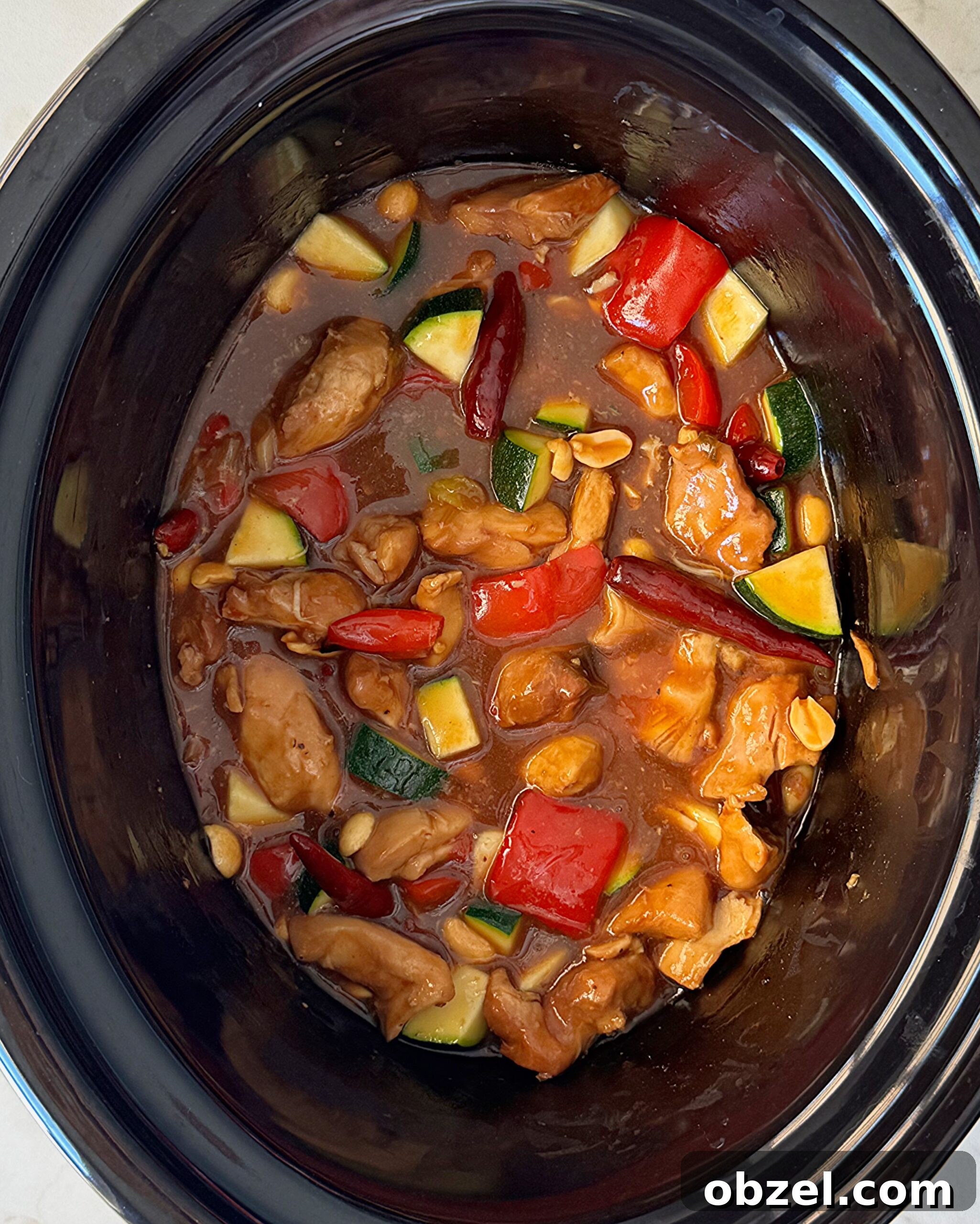 uncooked Kung Pao Chicken in slow cooker with peanuts & zucchini