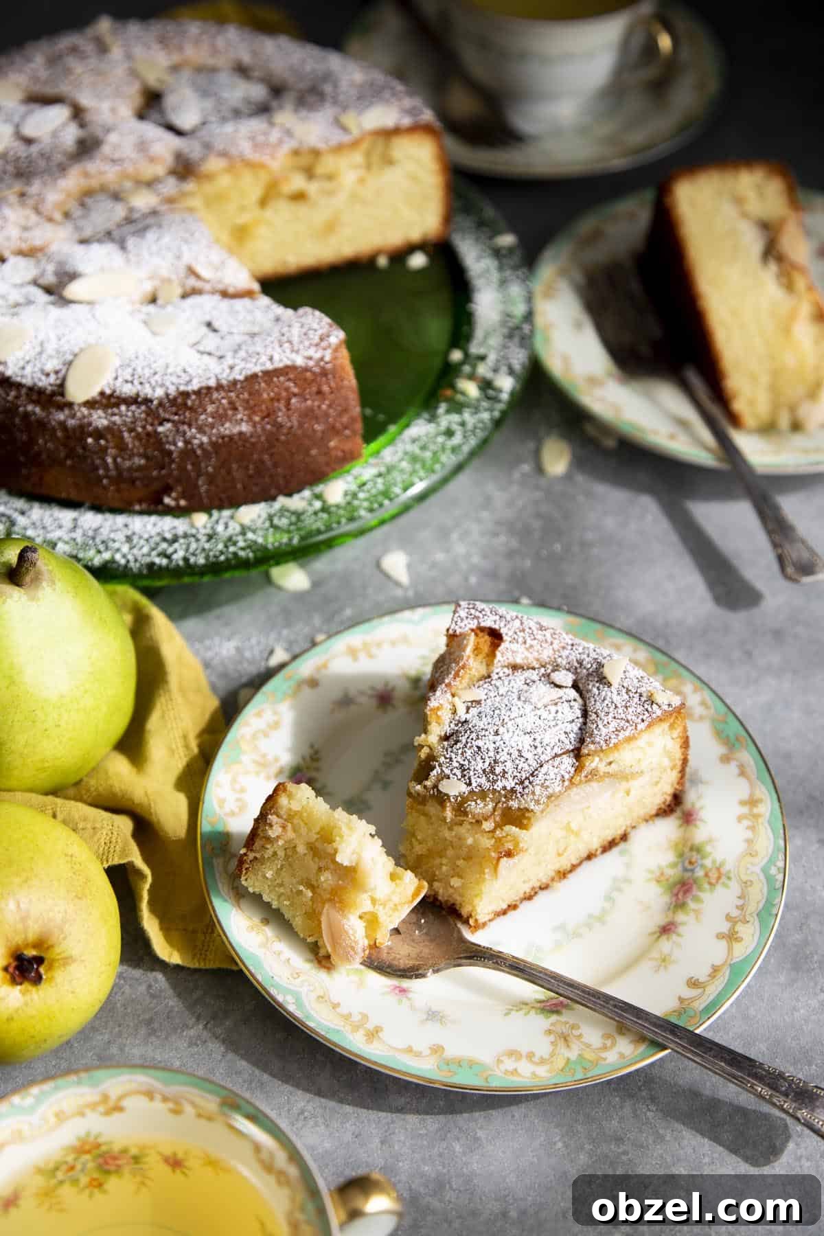 Pear Almond Cake made with almond flour, ripe pears, and sweet almond flavor A slice of almond pear cake on a plate with a fork