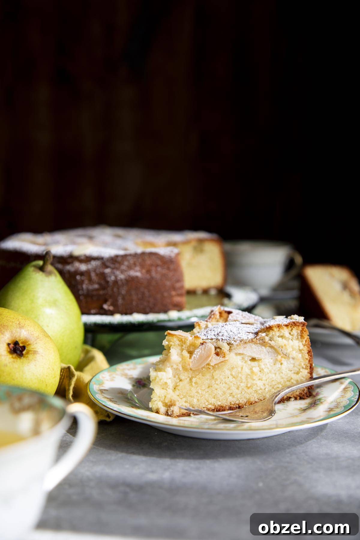 A slice of Pear Almond Cake showing the moist almond flour crumb A slice of cake on a plate with a fork showing the cake internal texture