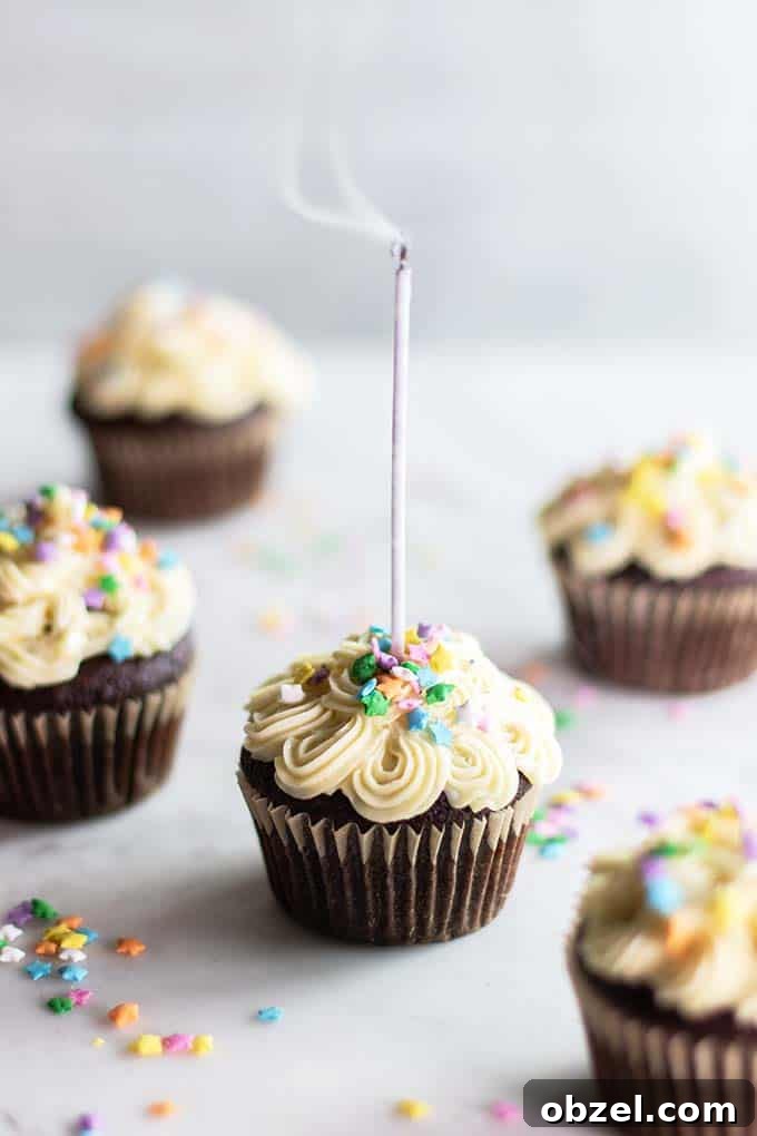 Gluten Free Chocolate Cupcakes Recipe 6 Almond flour cupcakes with a candle being blown out.