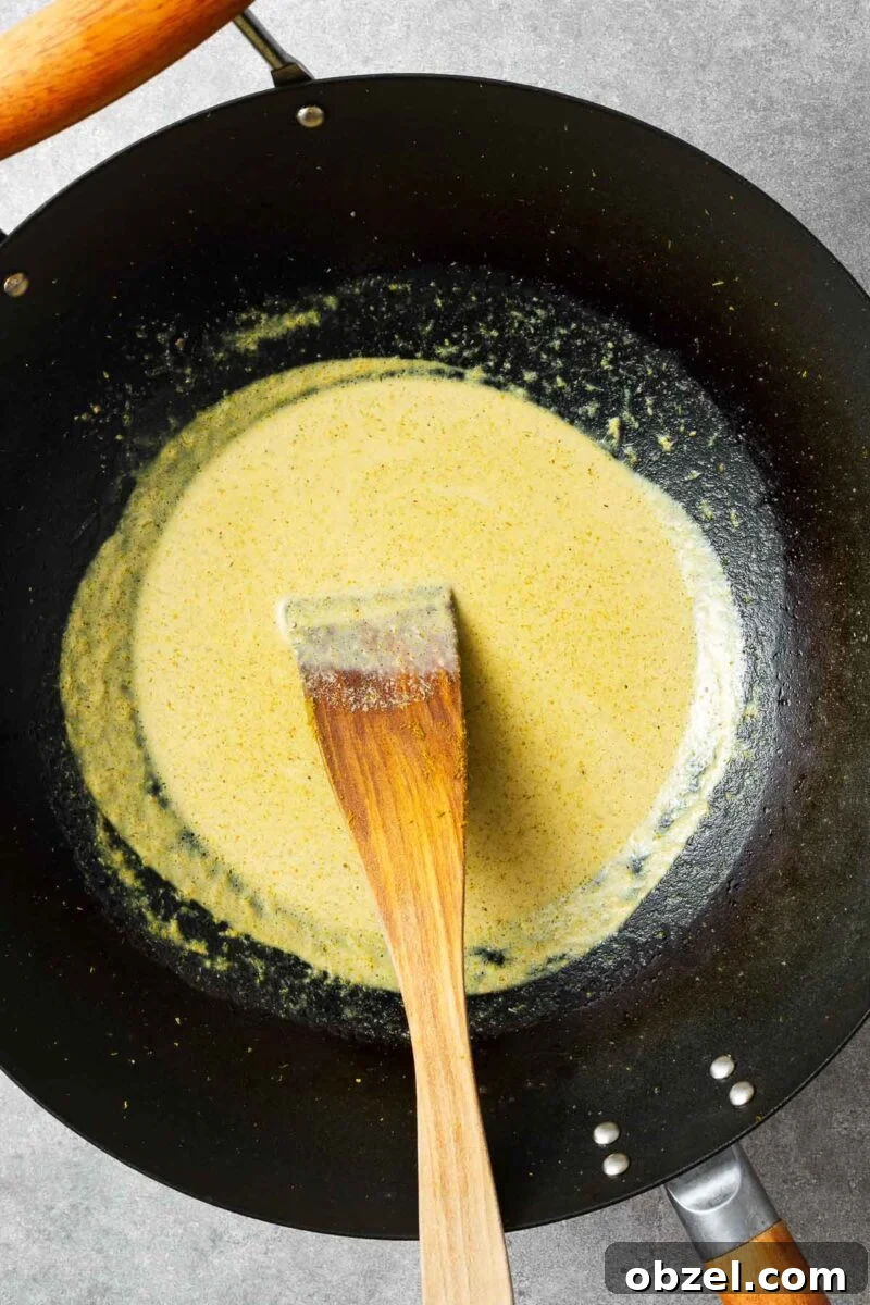 5 Ingredient Thai Green Curry Recipe 5 Making green curry sauce with green curry paste and coconut oil.