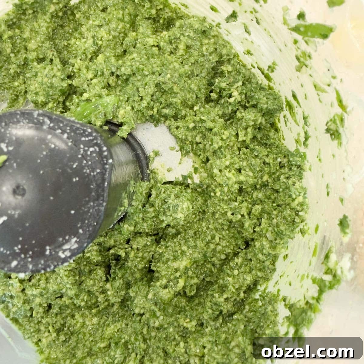 Authentic Pesto alla Genovese Recipe 4 Bright green basil pesto in a food processor work bowl.